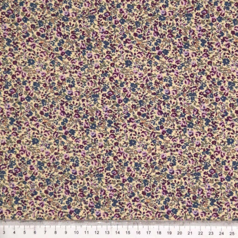 Purple ditsy floral print on needlecord fabric with a cm ruler