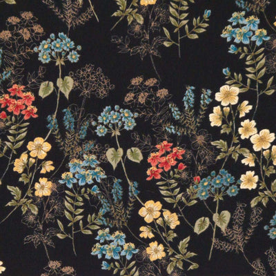 Wild flowers are printed on a black viscose fabric