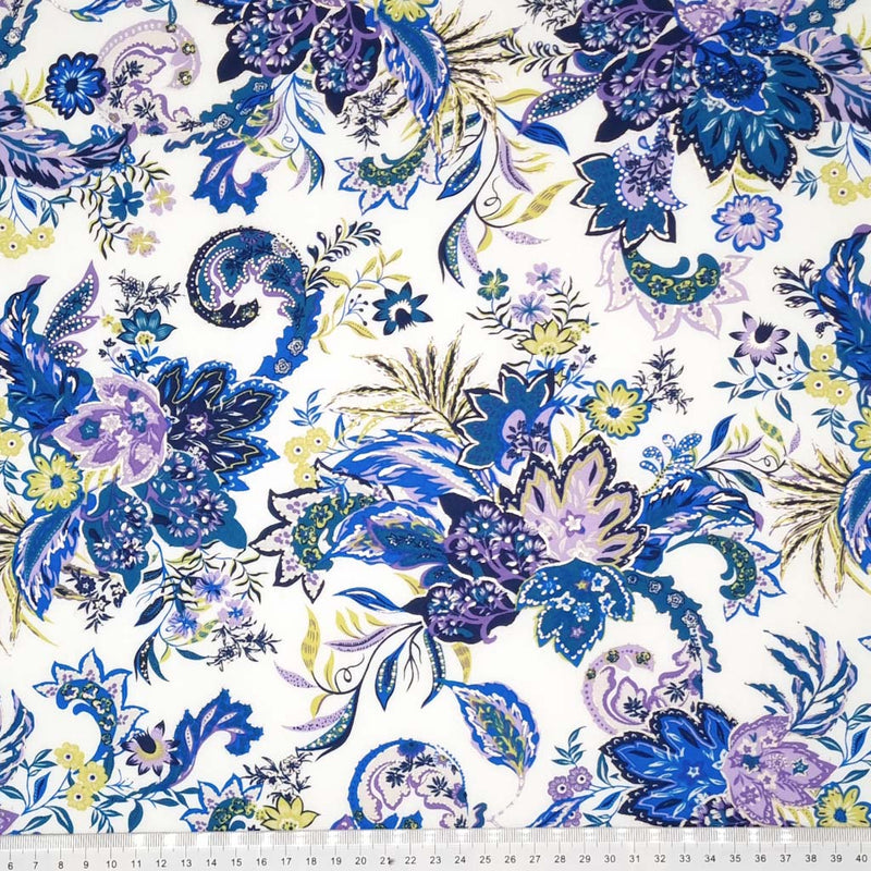 A large purple floral fabric printed on a white viscose fabric with a cm ruler