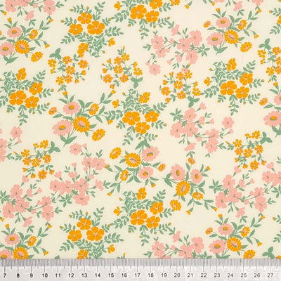 Calendula flowers are printed on this cream polycotton fabric with a cm ruler