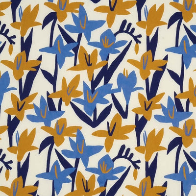 Blue and mustard Lily flowers are printed on a cream polycotton fabric.