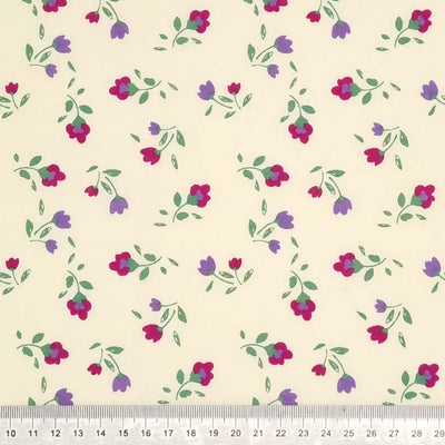 Bright cerise and purple tulip flowers are printed on a cream polycotton fabric with a cm ruler