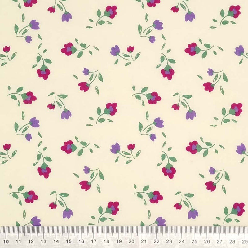 Magenta and lilac flowers printed on a cream polycotton fabric