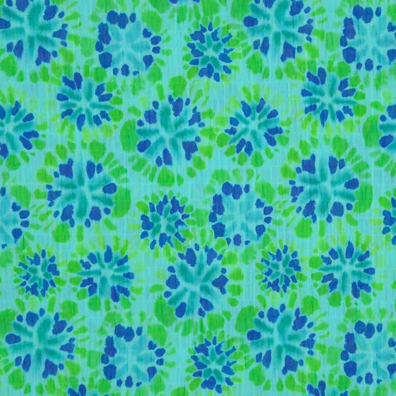 Tie dye flower shapes printed on a green crinkle effect fabric