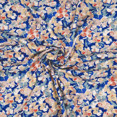 Floral pattern with small flowers in red, white, and blue on a blue viscose fabric