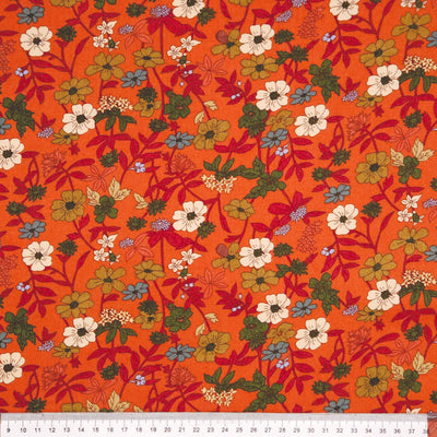 Floral pattern on an orange viscose fabric with a ruler
