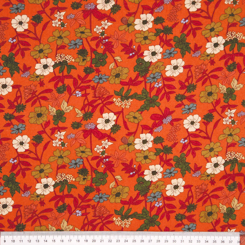 Floral pattern on an orange viscose fabric with a ruler