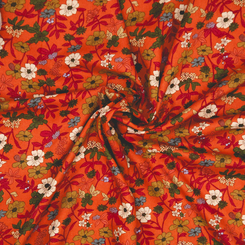Floral pattern on an orange viscose fabric