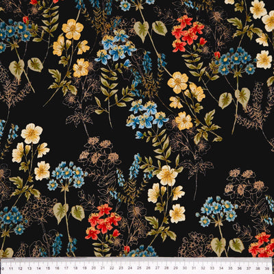 Floral pattern with red, yellow, and blue flowers on a black viscose marocaine with a cm ruler