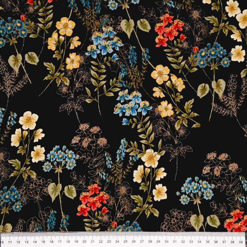 Floral pattern with red, yellow, and blue flowers on a black viscose marocaine with a cm ruler