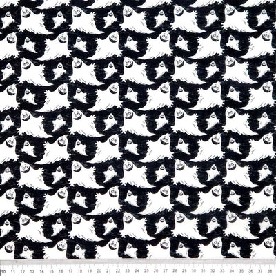Pattern of white ghosts on a black halloween polycotton fabric with a cm ruler