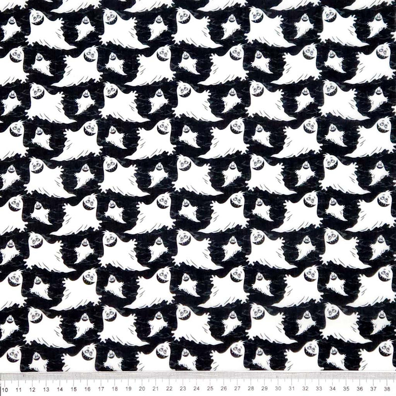 Pattern of white ghosts on a black halloween polycotton fabric with a cm ruler