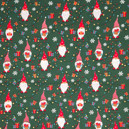 Pattern of Christmas gnomes, presents, and snowflakes on a green cotton fabric