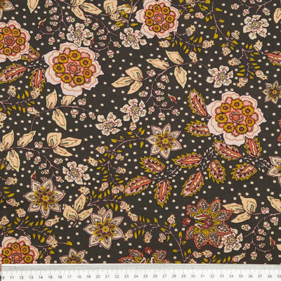 Floral pattern with multicolored flowers on a dark viscose fabric with a cm ruler