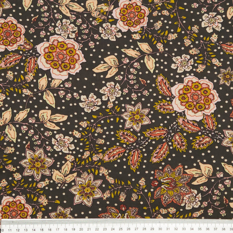 Floral pattern with multicolored flowers on a dark viscose fabric with a cm ruler