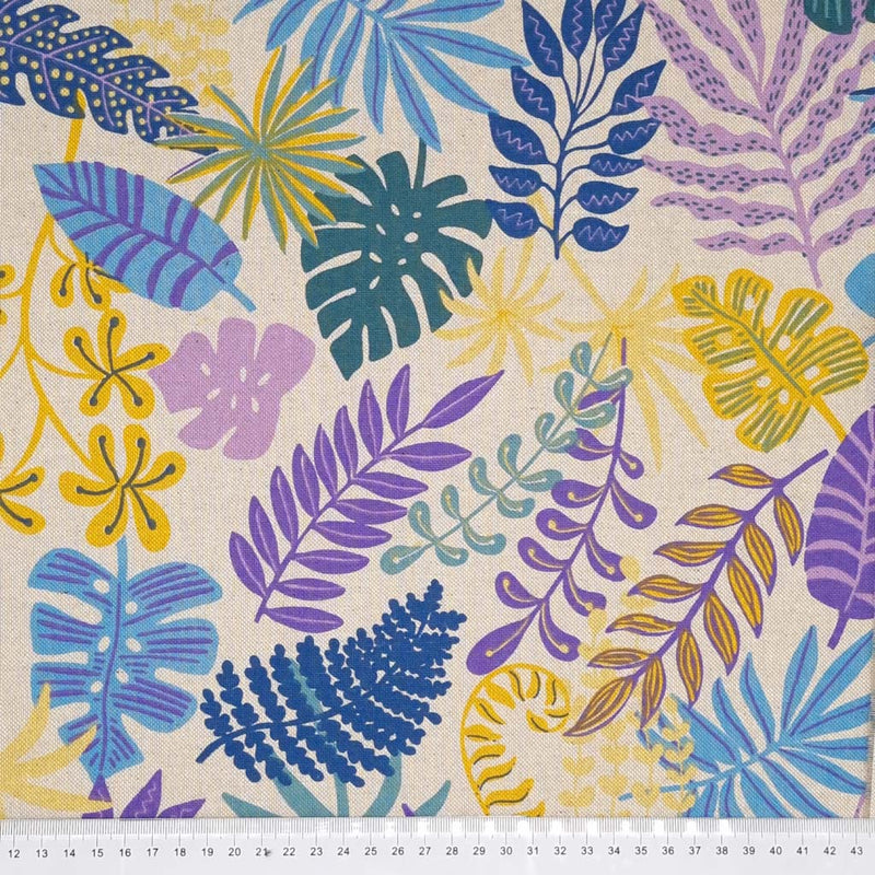 Lilac and blue tropical leaves are printed on a half panama fabric with a cm ruler