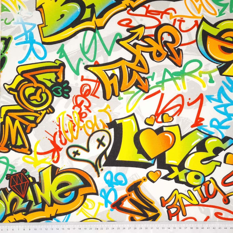 Brightly coloured graffiti is printed on a half panama fabric with a cm ruler