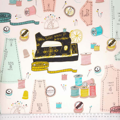 Sewing patterns and a sewing machine image is printed on a panama fabric with a cm ruler