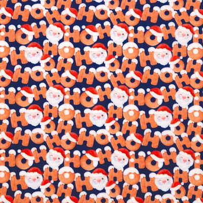 Pattern of 'HO HO HO' text and Santa Claus faces on a blue christmas polycotton fabric