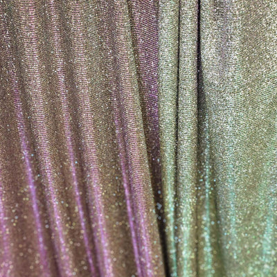 Close-up of iridescent fabric with purple and green hues