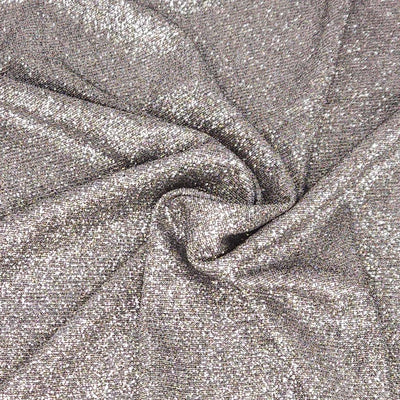 Close-up of silver glittery fabric with folds
