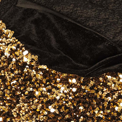Close-up of black velvet fabric with gold sequins