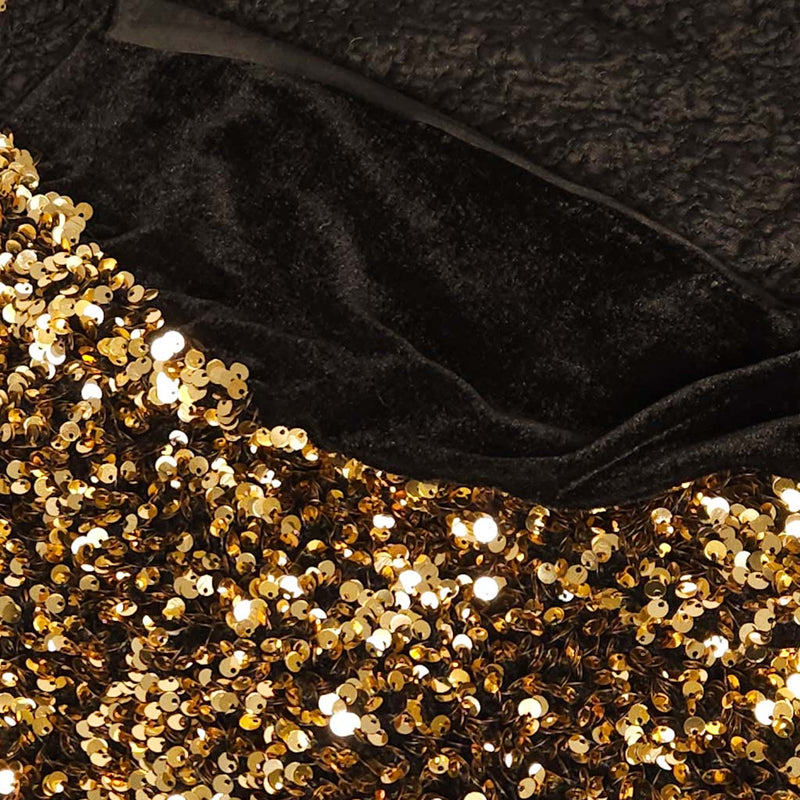 Close-up of black velvet fabric with gold sequins