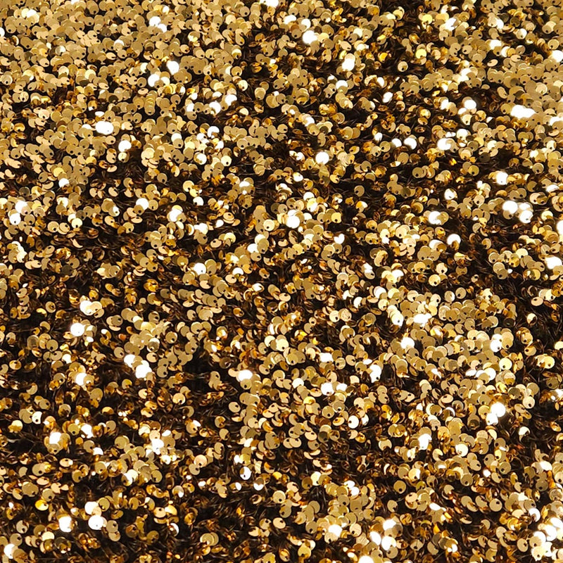 Close-up of gold glitter on a black velvet fabric
