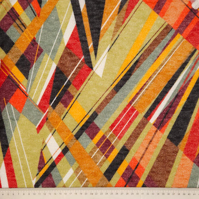 Abstract argyle print with glitter on a stretch fabric with a cm ruler