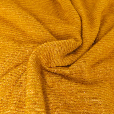 Close-up of textured mustard yellow fabric