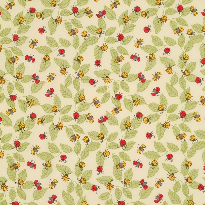 Red and yellow ladybirds printed on an ivory polycotton fabric