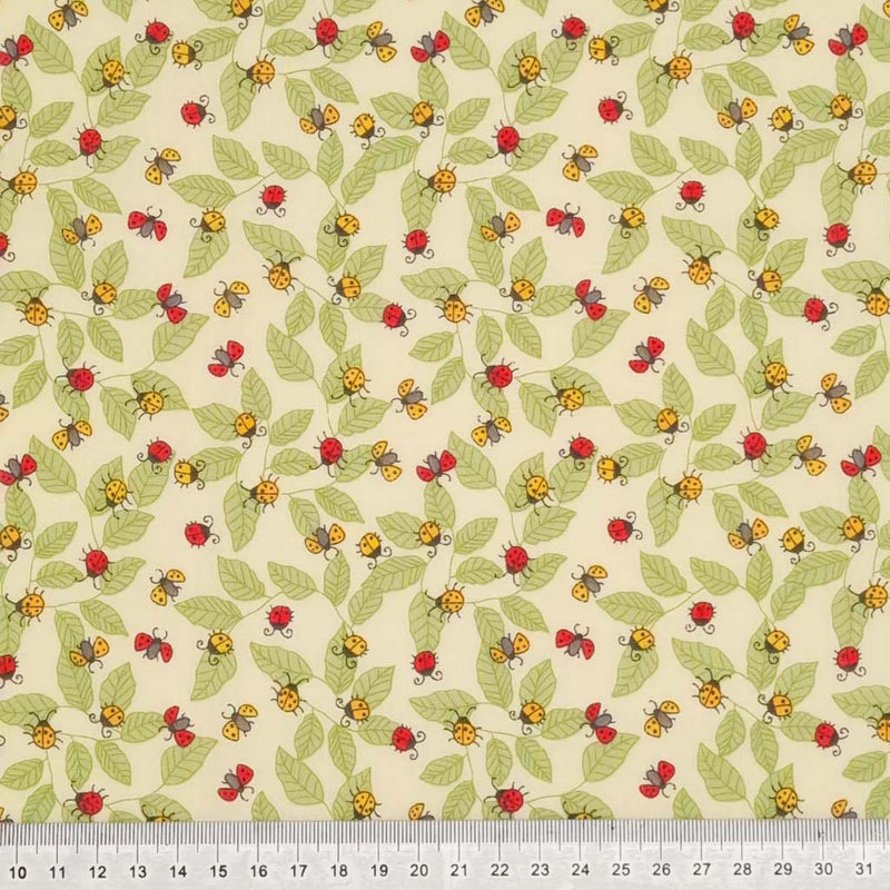 Red and yellow ladybirds printed on an ivory polycotton fabric with a cm ruler 