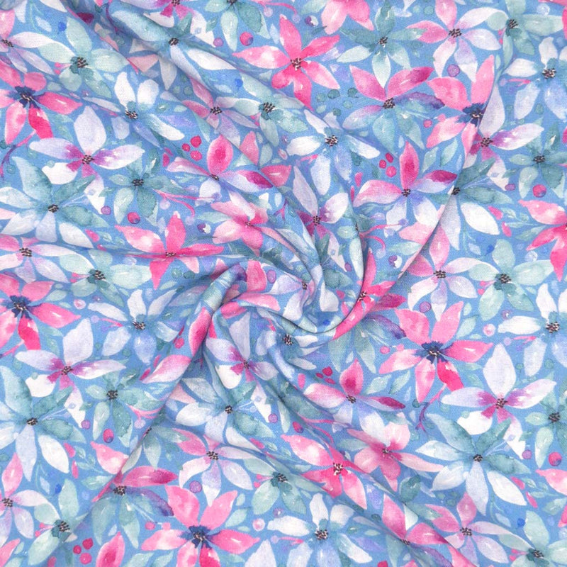 Pink flowers printed on a blue linen viscose mix fabric in a swirl