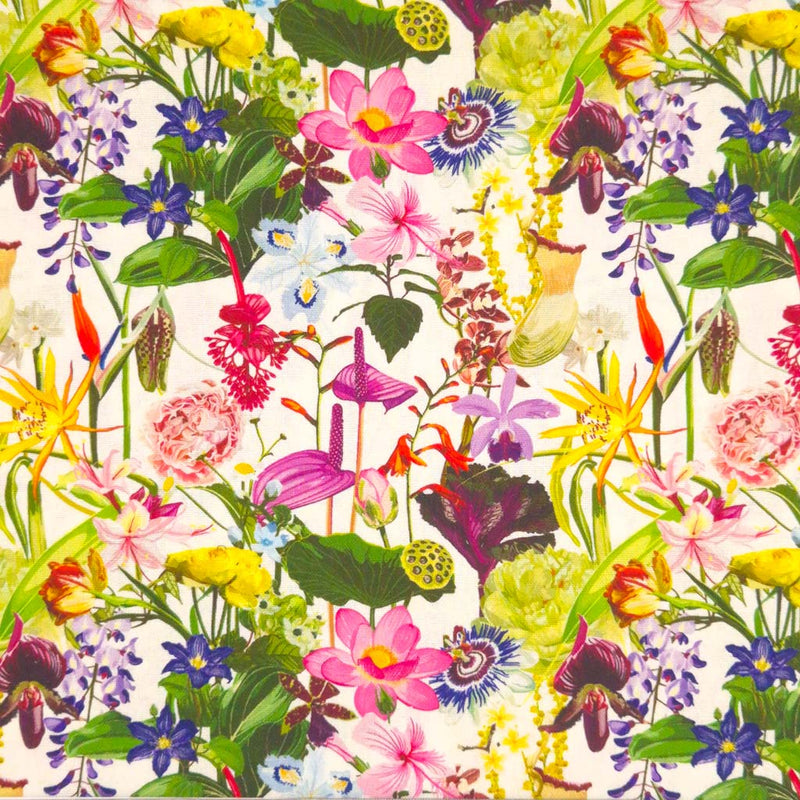 A colourful array of tropical wild flowers and leaves on a contrasting cream linen fabric background.