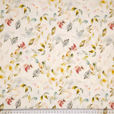 Multicolored leaf pattern on a white linen fabric with a ruler at the bottom.