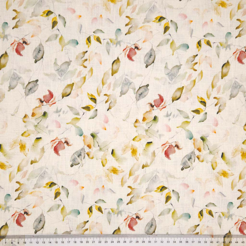 Multicolored leaf pattern on a white linen fabric with a ruler at the bottom.