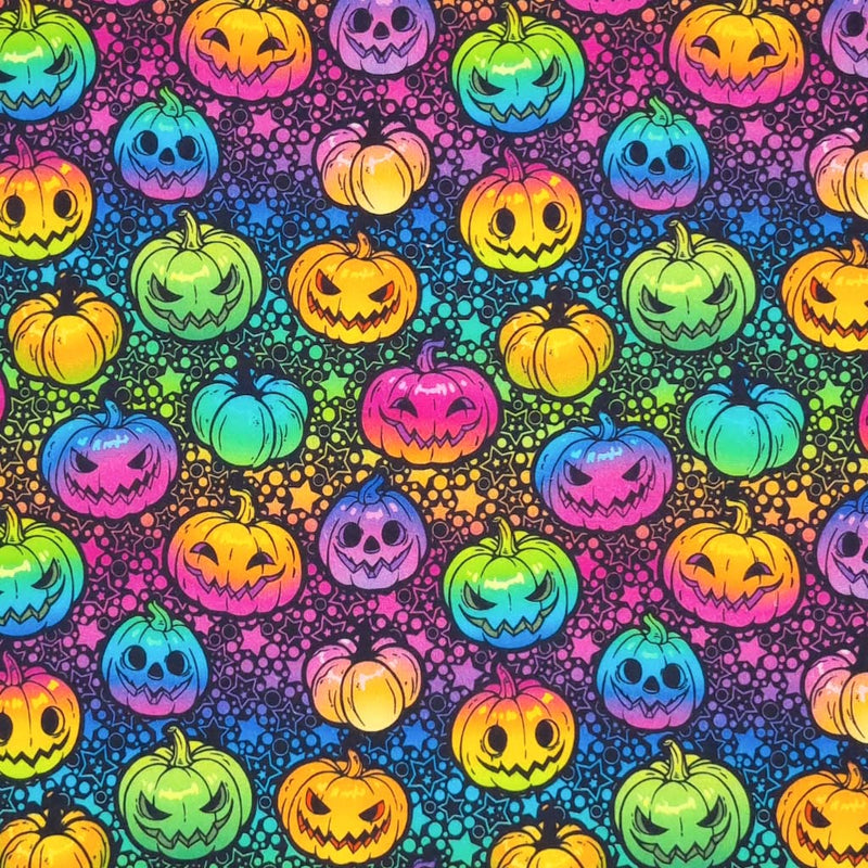 Brightly coloured neon pumpkins are printed on a black cotton fabric by Little Johnny