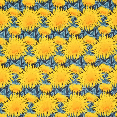 Bright yellow chrysanthemum flowers printed on a blue needlecord fabric by Little Johnny