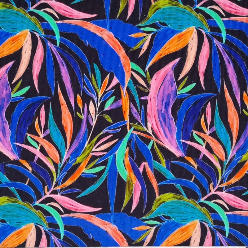 A vibrant design of garden leaves in neon colours on a plain black cotton needlecord fabric