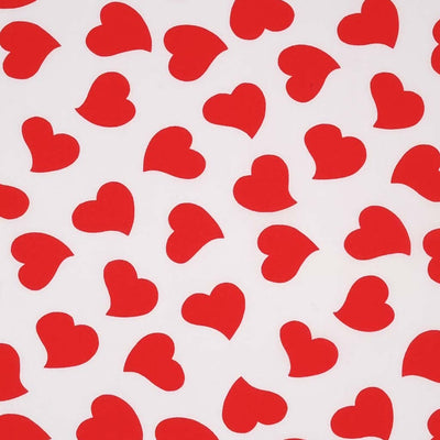 Red love hearts are printed on a plain white, quality polycotton fabric