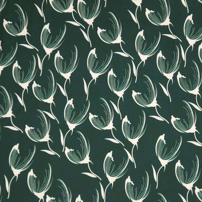 Pattern of white tulips on a dark green viscose twill fabric