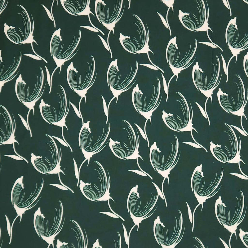 Pattern of white tulips on a dark green viscose twill fabric