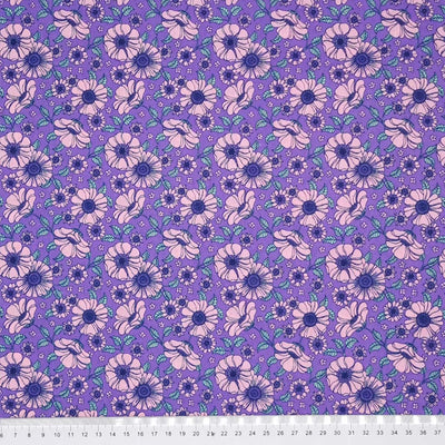 A vintage floral design featuring pink flowers on a lilac polycotton fabric with a cm ruler