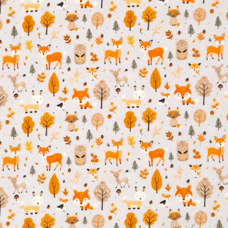 Pattern of foxes, deer, and trees on a grey needlecord fabric