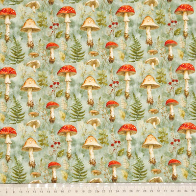 Pattern of mushrooms and foliage on a needlecord fabric with a ruler at the bottom.