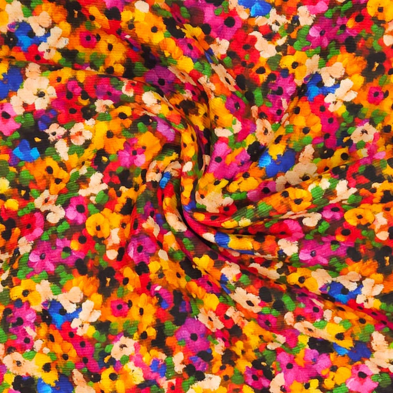 Colourful needlecord fabric with a pattern of small flowers in various colors.