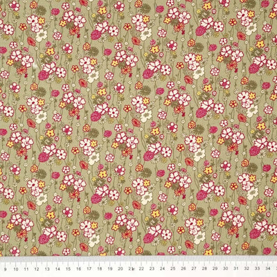A retro floral design printed on a sage green cotton needlecord fabric with a cm ruler