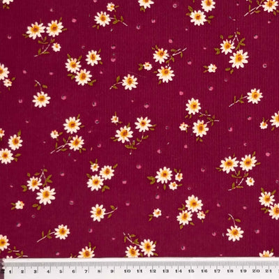 corduroy fabric featuring a cute, daisy and spots design is made from 100% cotton fibres with ruler