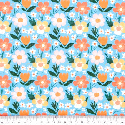 Floral pattern with orange, yellow, and white flowers on a blue polycotton fabric