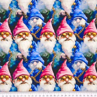 Pattern of gnomes with pink hats and gold sunglasses on a blue cotton fabric with a ruler at the bottom.